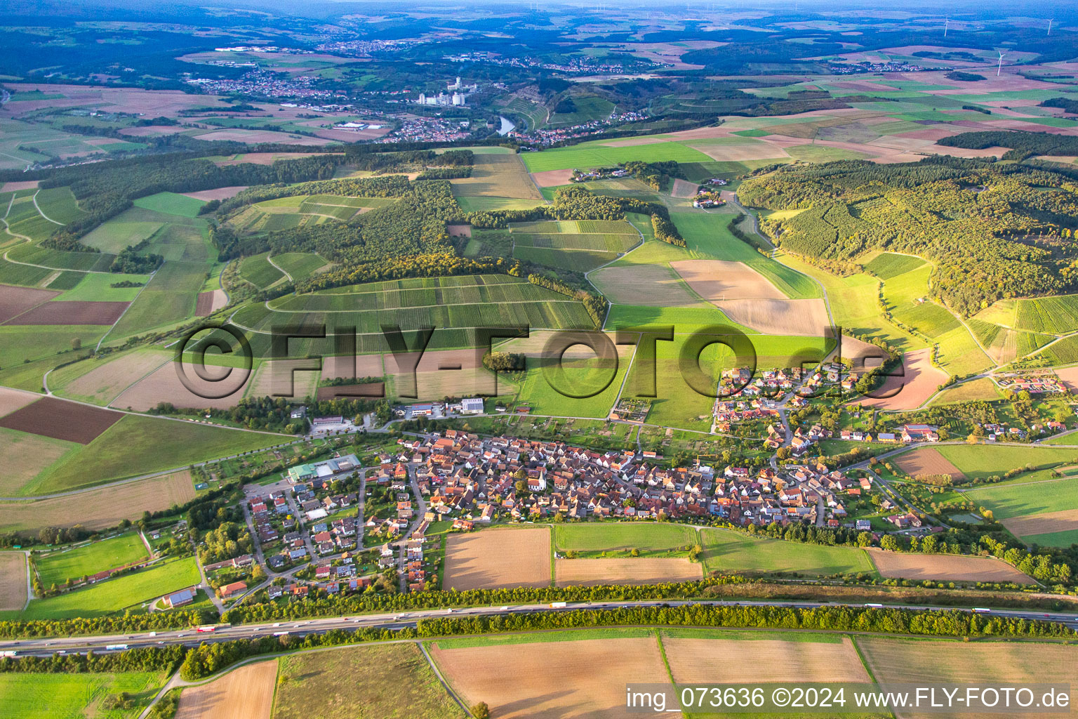 Vue aérienne de Village - vue derrière l'autoroute A3 en bordure de champs agricoles et de terres agricoles à le quartier Dertingen in Wertheim dans le département Bade-Wurtemberg, Allemagne