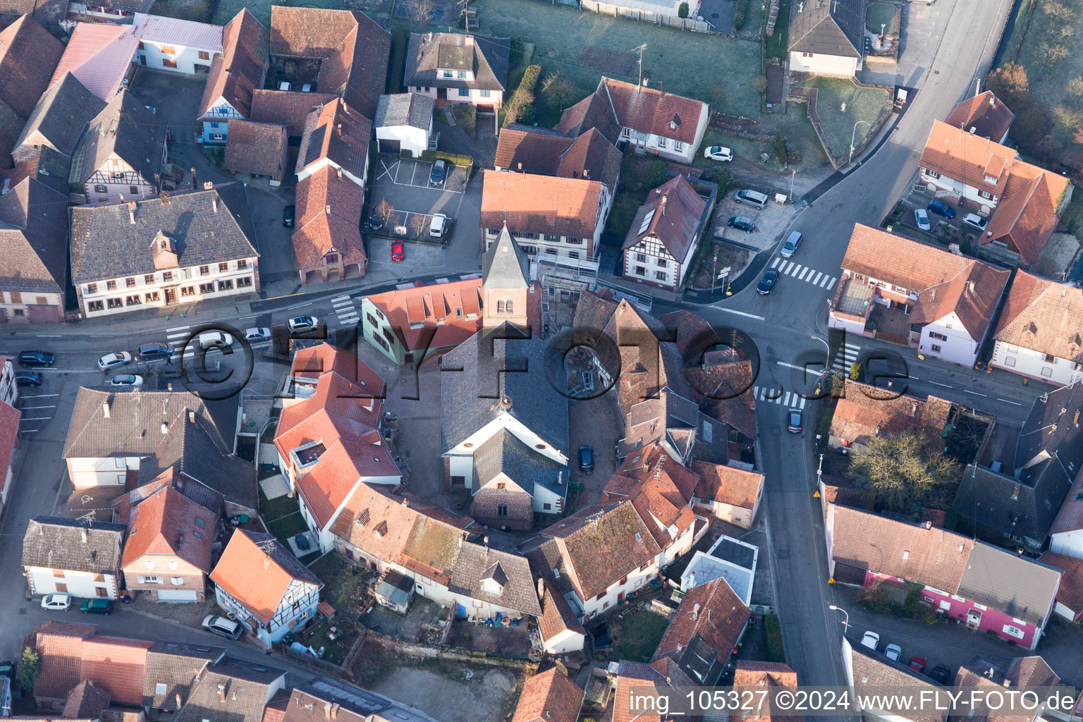 Église fortifiée luthérienne-protestante au centre du village entourée d'un anneau de maisons à Dossenheim-sur-Zinsel dans le département Bas Rhin, France hors des airs