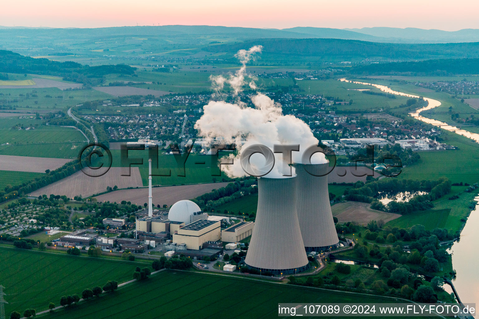 Vue aérienne de Blocs réacteurs, structures et systèmes de tour de refroidissement de la centrale nucléaire - centrale nucléaire - centrale nucléaire Grohnde sur la Weser au coucher du soleil en Grohnde à le quartier Grohnde in Emmerthal dans le département Basse-Saxe, Allemagne