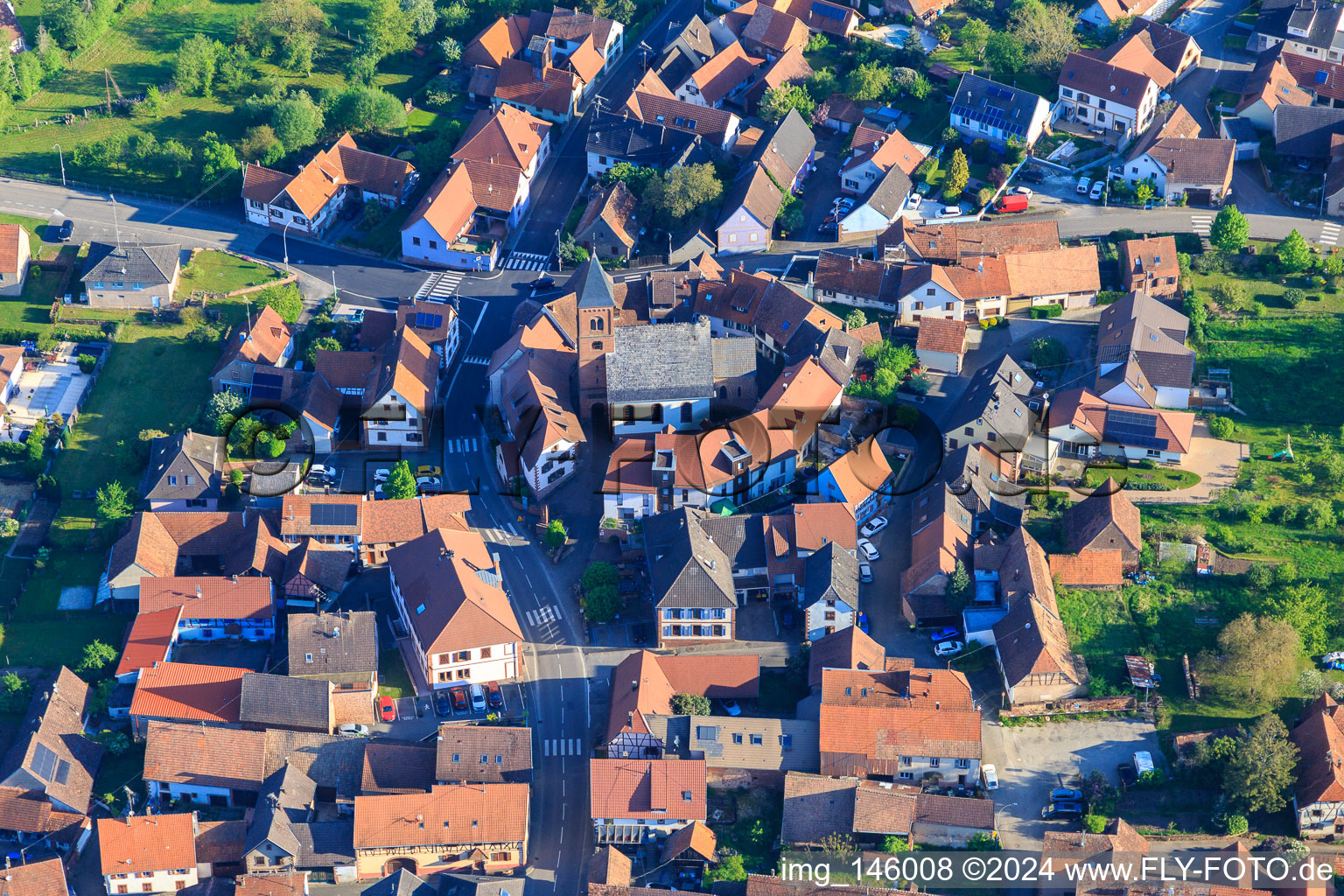 Vue aérienne de Église protestante luthérienne en tant qu'église fortifiée entourée d'un cercle de maisons à Dossenheim-sur-Zinsel dans le département Bas Rhin, France