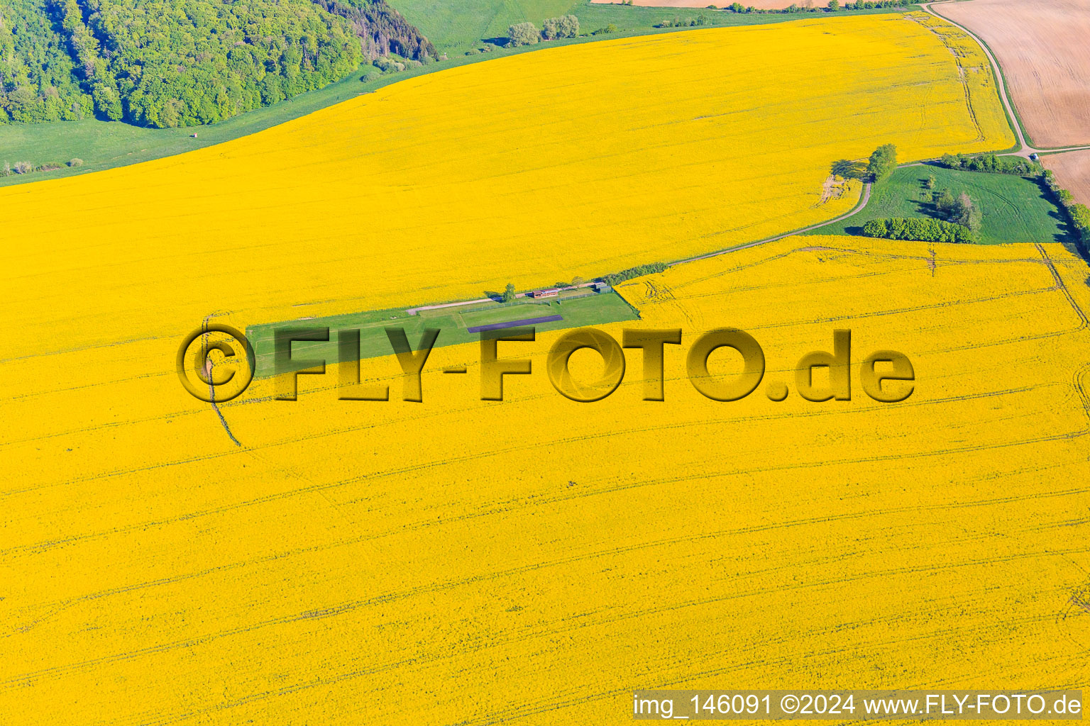 Vue aérienne de Aérodrome modèle dans un champ de colza en fleurs à Gros-Réderching dans le département Moselle, France