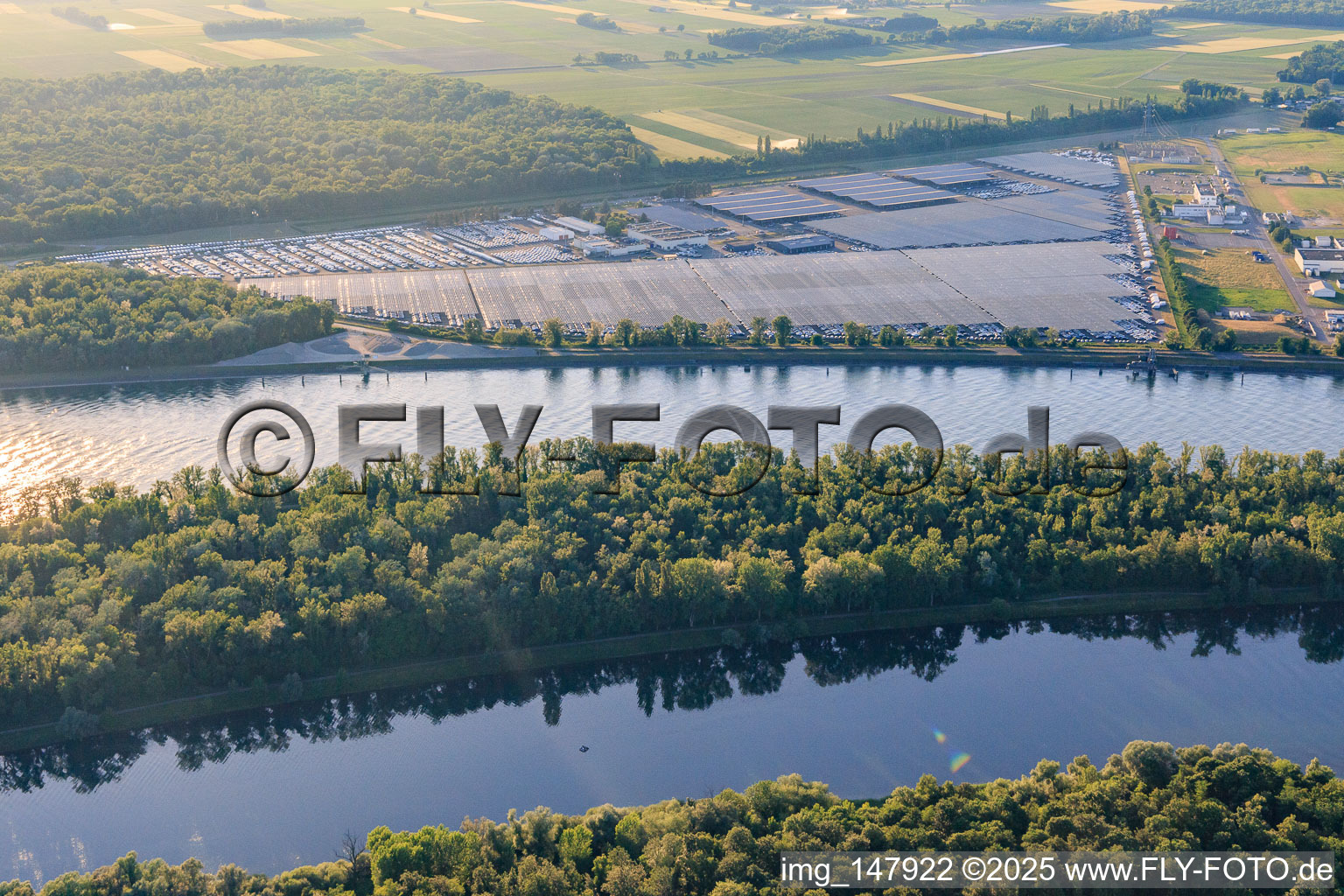 Vue aérienne de Zone industrielle et portuaire avec entrepôt de voitures CEVA Logistics ombragé par des systèmes photovoltaïques à Marckolsheim dans le département Bas Rhin, France