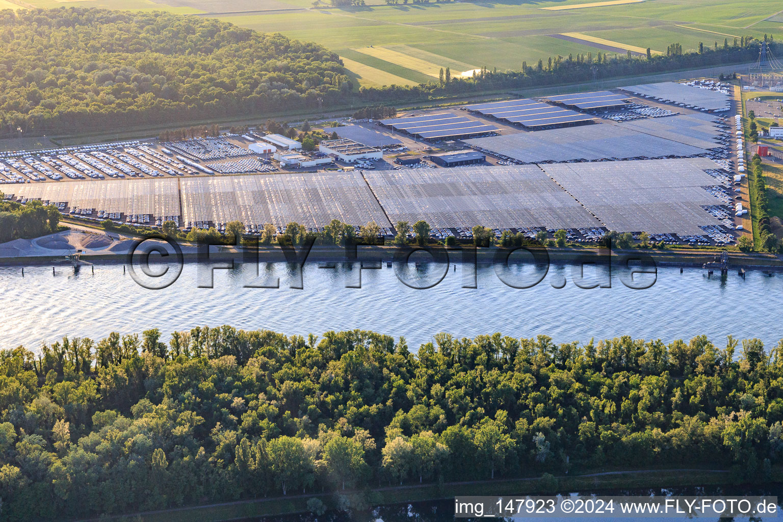 Vue aérienne de Zone industrielle et portuaire avec entrepôt de voitures CEVA Logistics ombragé par des systèmes photovoltaïques à Marckolsheim dans le département Bas Rhin, France