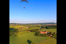Vue aérienne de Parapente au-dessus du domaine Mariaburghausen avec l'église Saint-Jean-Baptiste Mariaburghausen à le quartier Mariaburghausen in Haßfurt dans le département Bavière, Allemagne