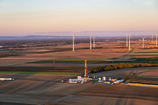 Site de forage profond « Rig V20 - Vercana » (Vulcan Energy) au Schleidberg, avec le parc éolien d'Offenbach en arrière-plan, dans la lumière du soir ; installation destinée à l'exploitation de la géothermie et à l'extraction de lithium à Insheim dans le département Rhénanie-Palatinat, Allemagne