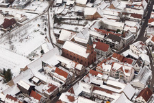 Vue aérienne de Église protestante hivernale et enneigée au centre du village à Steinweiler dans le département Rhénanie-Palatinat, Allemagne
